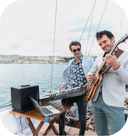 Two musicians playing on our catamaran