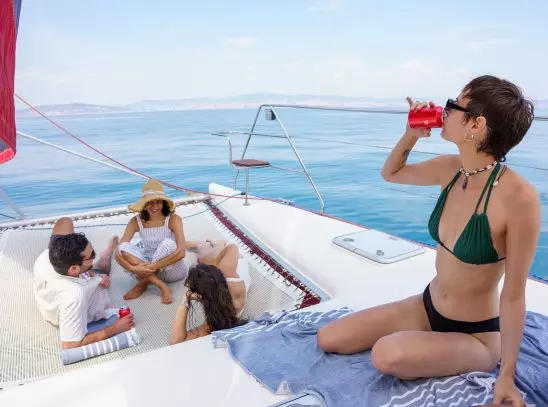 Tres viajeros disfrutando del sol en la cubierta del barco